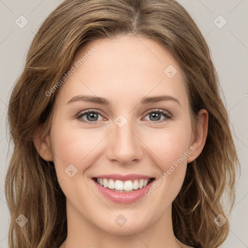 Joyful white young-adult female with long  brown hair and green eyes