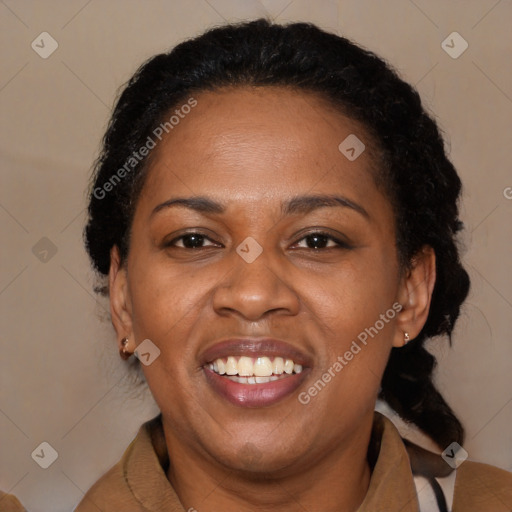 Joyful black adult female with medium  brown hair and brown eyes