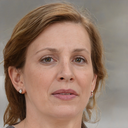 Joyful white adult female with medium  brown hair and grey eyes