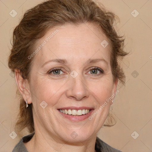 Joyful white adult female with medium  brown hair and grey eyes