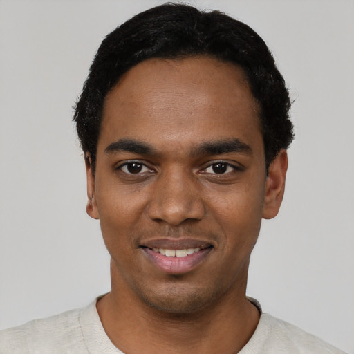 Joyful black young-adult male with short  black hair and brown eyes