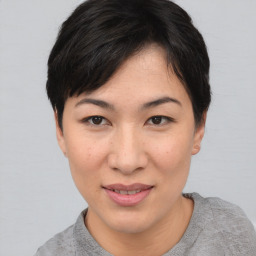 Joyful asian young-adult female with short  black hair and brown eyes