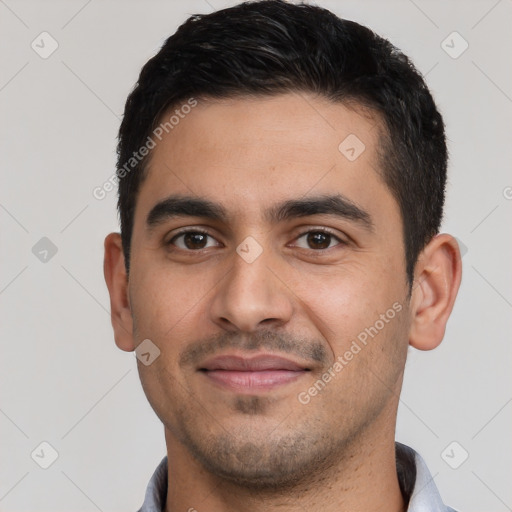 Joyful white young-adult male with short  black hair and brown eyes