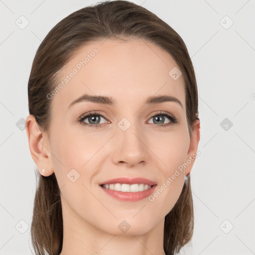 Joyful white young-adult female with long  brown hair and grey eyes