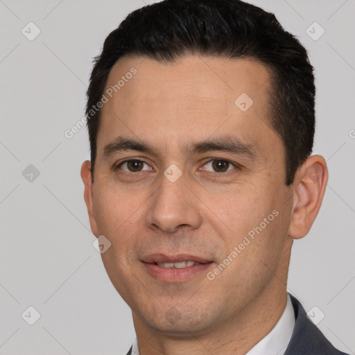 Joyful white young-adult male with short  black hair and brown eyes