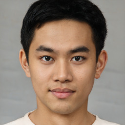 Joyful asian young-adult male with short  black hair and brown eyes