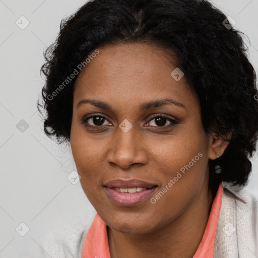 Joyful black adult female with long  brown hair and brown eyes