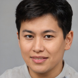 Joyful asian young-adult male with short  brown hair and brown eyes