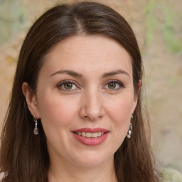 Joyful white young-adult female with long  brown hair and green eyes