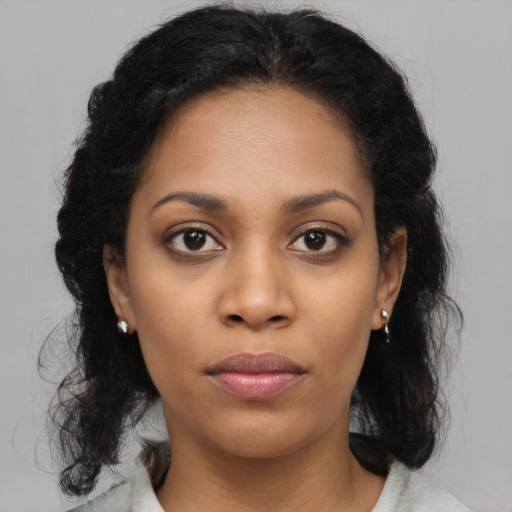 Neutral black young-adult female with medium  brown hair and brown eyes