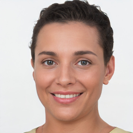 Joyful white young-adult female with short  brown hair and brown eyes