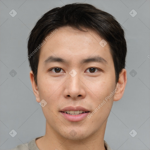 Joyful asian young-adult male with short  brown hair and brown eyes