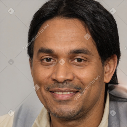 Joyful latino adult male with short  black hair and brown eyes