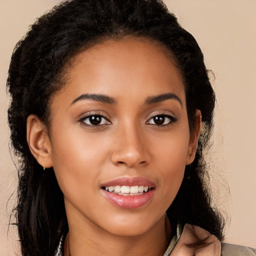 Joyful latino young-adult female with long  brown hair and brown eyes