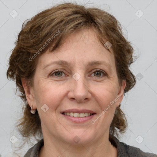 Joyful white adult female with medium  brown hair and grey eyes