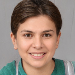 Joyful white young-adult female with short  brown hair and grey eyes