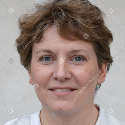 Joyful white adult female with short  brown hair and brown eyes