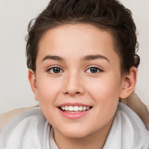 Joyful white child female with short  brown hair and brown eyes