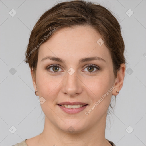 Joyful white young-adult female with medium  brown hair and green eyes