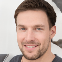 Joyful white young-adult male with short  brown hair and brown eyes