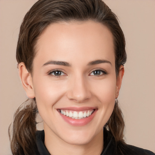 Joyful white young-adult female with long  brown hair and brown eyes