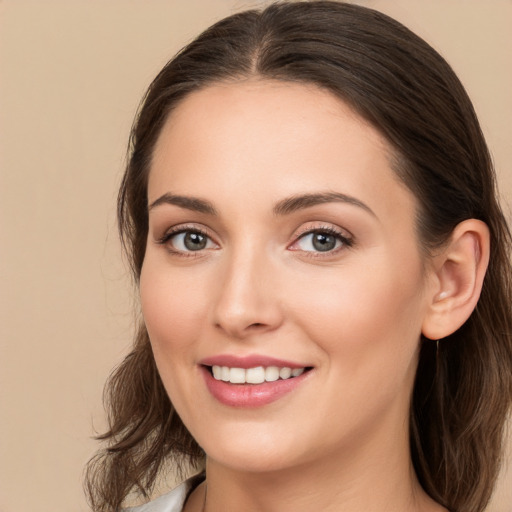 Joyful white young-adult female with medium  brown hair and brown eyes