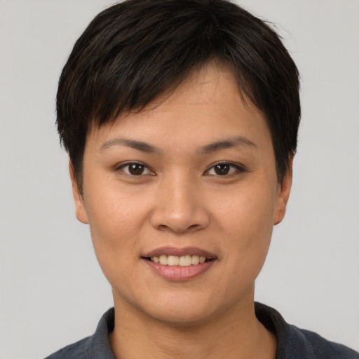 Joyful asian young-adult female with short  brown hair and brown eyes