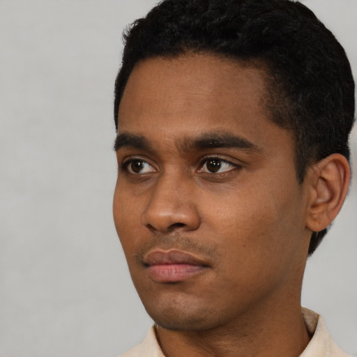 Neutral latino young-adult male with short  black hair and brown eyes