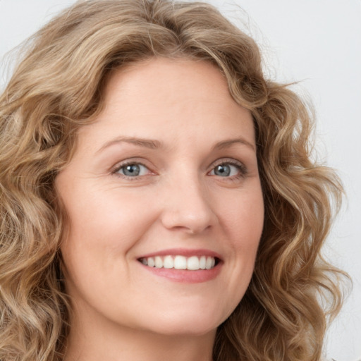 Joyful white young-adult female with long  brown hair and green eyes