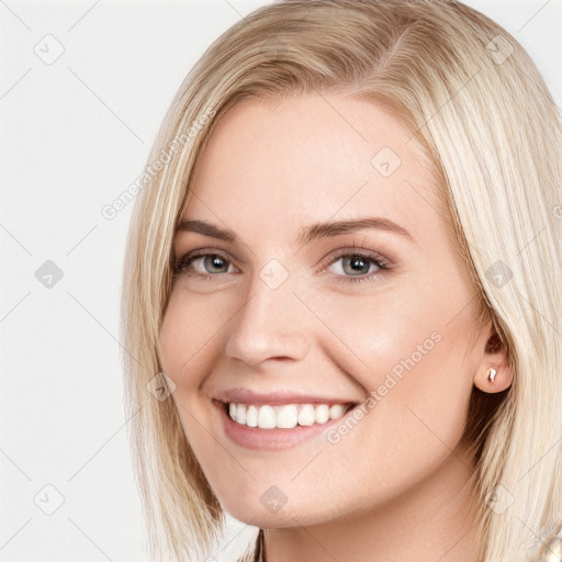 Joyful white young-adult female with long  brown hair and blue eyes