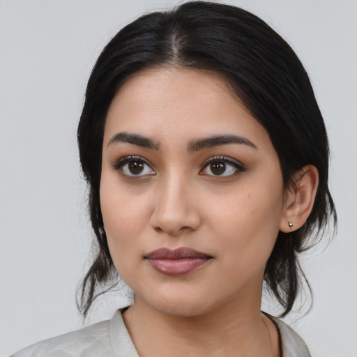 Neutral latino young-adult female with medium  black hair and brown eyes