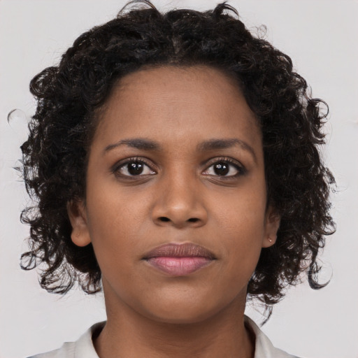 Neutral black young-adult female with medium  brown hair and brown eyes