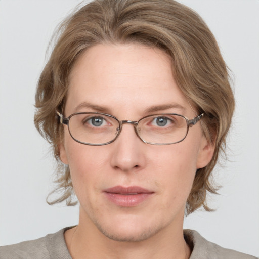 Joyful white adult female with medium  brown hair and blue eyes