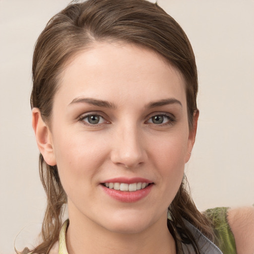 Joyful white young-adult female with medium  brown hair and grey eyes