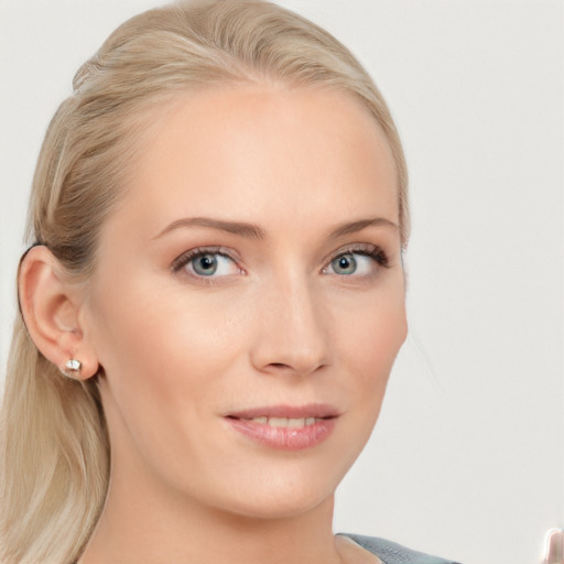 Joyful white young-adult female with long  brown hair and blue eyes