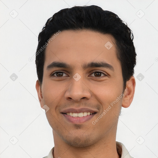 Joyful latino young-adult male with short  black hair and brown eyes