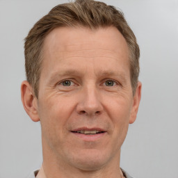 Joyful white adult male with short  brown hair and grey eyes