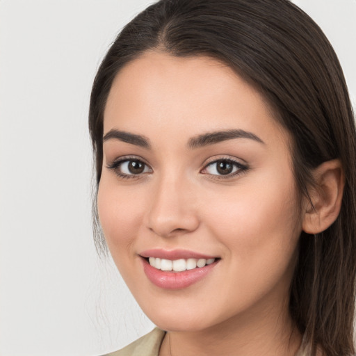 Joyful white young-adult female with long  brown hair and brown eyes