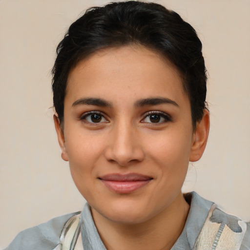 Joyful latino young-adult female with short  brown hair and brown eyes