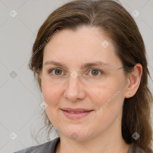 Joyful white adult female with medium  brown hair and grey eyes