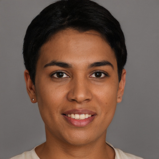 Joyful latino young-adult female with short  black hair and brown eyes