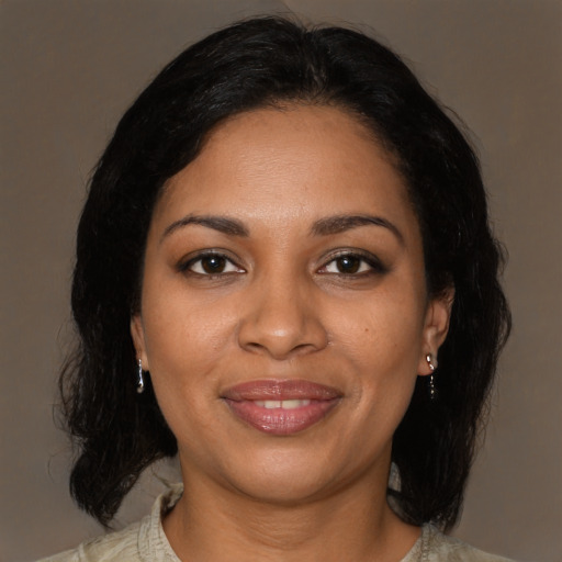 Joyful black young-adult female with medium  brown hair and brown eyes