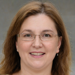 Joyful white adult female with medium  brown hair and brown eyes