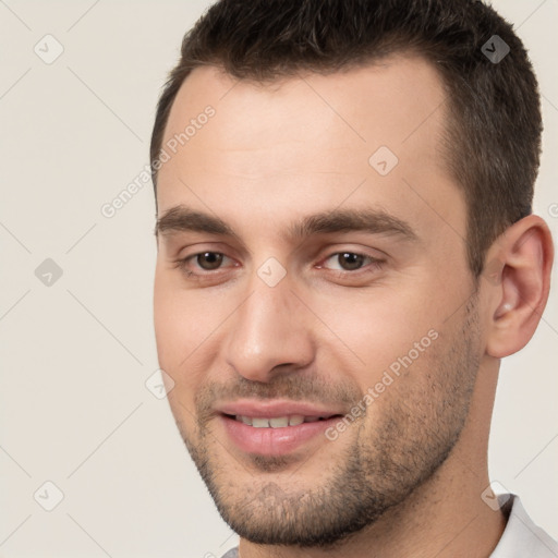 Joyful white young-adult male with short  brown hair and brown eyes