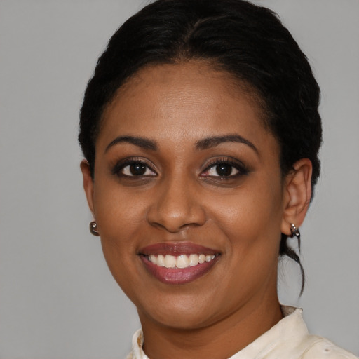 Joyful black young-adult female with short  brown hair and brown eyes