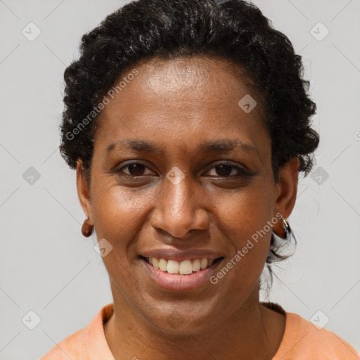 Joyful black adult female with short  brown hair and brown eyes