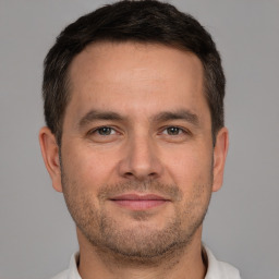 Joyful white adult male with short  brown hair and brown eyes