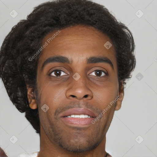 Joyful black young-adult male with short  brown hair and brown eyes