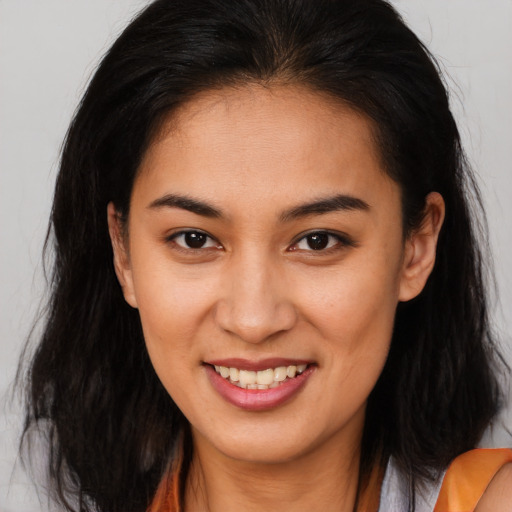 Joyful asian young-adult female with long  brown hair and brown eyes