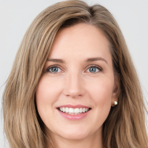 Joyful white young-adult female with long  brown hair and green eyes